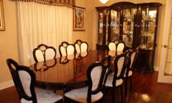 10 piece red mahogany diningroom set including 1 table(8 ft) , 8 chairs, and hutch(80" in width) with decorative glass.  Mint condition.