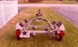 This roller boat trailer will handle a boat from 14 - 17 feet. It was used to move my 16' Starcraft. It has newer working lights, bearing buddies, great rubber on 13" rims.
The wishbone 3" steel box tubing is stronger than most trailers its size, accented
