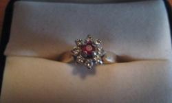 Very old, Past down in family. 14k Great Condition Has Red Ruby in the middle surrounded by 8 diamonds. Size 5