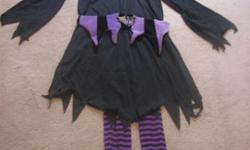 Friendly Witch Costume? Size Medium 8 ? 10 - Pretty in purple if she may, all dressed up for Halloween day! The Witch Child costume includes: A black frock style dress with belt, purble and black hat and purple wig. A pair of purple and black striped