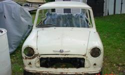 Rolling shell, front subframe with Cooper S hubs/calipers, rear subframe drum brakes. 10" steel wheels. 3 doors= 2 complete Coopers. All glass less windscreen. Complete 850cc motor and transmission( time warp) turns free but has not been run in many