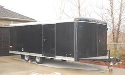 Drive on / Drive off, 18' 6" x 8' (inside dimensions) 4 bed enclosed snowmobile or ATV trailer. Steel frame with no cracks or rot, torsion axles, barn doors on the front and back, 2 ramps, (1 stored under the rear of the trailer, the other hangs on the