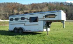 This is a very nice trailer. 3H slant w/ folding rear tack room with 3 saddle racks, bridle racks and weekender living quarters with lots of cabinets and storage space, lights in sleeping area and tile countertop. Some of the padding on the dividers has a