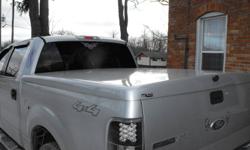 Fibre glass tonneau cover... fits '04 -'08 F150 4Door truck with 5 1/2 foot box... Silver, Good lift cylinders, Locking (with key).