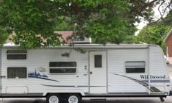 2006 Wildwood Trailer 27 Ft. by Forest River. Very clean and well maintained. Queen island bed. Sofa bed sleeps 2 plus double bed and a bunk on top. 3 burner stove. Large 2 door fridge with freezer. All appliances work and was tested by Johnsons Rv.