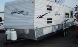 * 32FT TRAVEL TRAILER WITH 7FT SLIDE OUT L/SIDE AND A 6FT REAR SLIDE OUT PLUS A 21FT AWNING * SLEEPS 10 PERSONS, HAS DUAL SINK, 3 BURNER STOVE/OVEN, MICROWAVE, REFRIDGERATOR/FREEZER, A/C, FULL BATH/SHOWER, SMALL FLAT TV