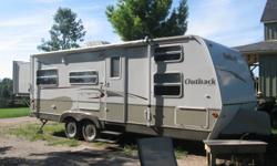 2007 KEYSTONE OUTBACK 26RS TRAILER- 26 foot long with queen size bed slide out the back, has 4 bunks in the front. The table and couch also folds down to sleep a total of 10 people.    Has full kitchen with sink, stove, oven,  fridge, stereo, TV  and