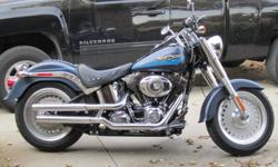 Grandfather driven, kept in heated garage, fair weather ridden only.  Fat Boy Denim Blue 96 cubic inch, 6 speed transmission, Vance & Hines exhaust, internally wired pull back bars and lots of Harley Davidson chrome extras.