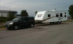 A fantastic family trailer with quad bunks in the back, largest in the industry kitchen counter and storage space (garage space and large front compartment) with a full queen bedroom at the front. Top of the line, great condition. Many upgrades. DVD,