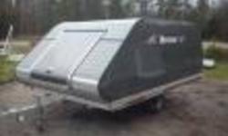 2012 BLACK TRITON ELITE BRAND NEW ENCLOSED SNOWMOBILE TRAILER. 11' LONG 101 WIDE WITH A LARGE (4'X4') FLIP UP DOOR ON THE FRONT OF TRAILER. COMES WITH A TONGUE JACK, SPRING LIFT KIT, SKI GUIDES/TRACTION. THERE ARE ONLY ONE OF THESE IN BLACK AVAILABLE FOR