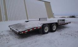 Heavy Duty Tandem trailer with loading ramps and 10 ton winch.  306-862-5639.
