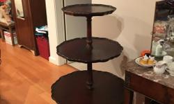A vintage 3 tier mahogany pie table with cabriole legs..
The table has scalloped edges.
The table is very sturdy and is in good condition considering its age.
The measurements are:
Top shelve - 13" in diameter
2nd shelve - 18" in diameter
3rd shelve - 24"