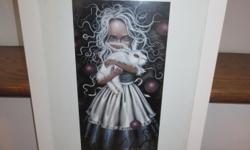 ANGELINA WRONA framed art print "Resurrection Mini-137". Overall size is 12 3/4" wide x 15 3/4 " high', size of print is 6" wide x 12" high.
Over the past 10 years, Angelina's artwork has earned international recognition by collectors and diehard loyalty
