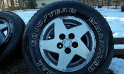 4 Good year Wrangler M+S P235/75R15 tires on 5 bolt jeep Aluminium wheels.
