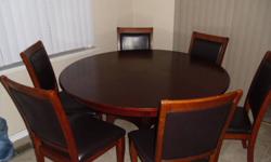 54 inch round table in good to fair condition minor damage on table due to being stored  .................................................
with 6 dark brown  walnut leather look  chairs not sure if there real