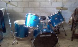 Five piece Ludwig kit, metallic blue with clear heads. This is an awesome starter kit. Comes with the stock single kicker and high hat stand AND a mapex double kick with an integrated high hat stand. I just put a new head on the snare and have used it