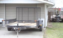 7X14 Heavy Duty Landscape Trailer
     Dual axle 14" tires
     2" coupler with jack stand
     8000 lb. load
     beaver tail gate, 12' sides
     5 pin light hookup
     never used in winter, excellent shape.
     asking $2200.00