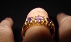 18k gold ring 
  three  amythest and
  four  diamond stones set in antique setting
  appraisal slip with detailed description
  valued at  $725.
