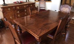 Beautifully restored turn of the century dining room suite made in England. A fine example of European hand crafted solid wood construction with intricate hand carved detailing.
Dining room table leaves open up from 5' to 7'6" with 2 self storing leaves