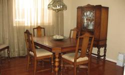 Beautiful solid wood dining room suite -  with 6 new professionally upholstered chairs and matching antique china cabinet. Lots of storage space inside cabinet, along with plenty of showcase space to display your finest china and crystal.