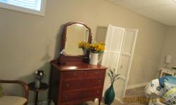 Antique dresser with 4 drawers, pivoting mirror and wheels. In great condition!!