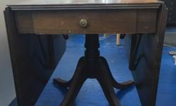 Antique drop leaf table with drawer on solid pedestal in good condition. Perfect for entertaining in a small space. Original finish, smoke free home.