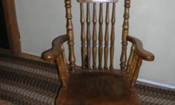 Antique rocker- at least 80 years old.  One arm is loose and can be reglued.