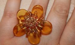 Local buyers only please -- I do not send things through the mail
Very summery golden yellow beaded flower ring. Ring itself is wrapped wire. Size 9 - band is wrapped wire, might be possible to resize it somehow if you're creative. Purchased from an