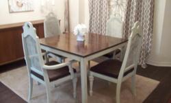 I have a beautiful shabby chic style beige/cream 5 piece dining table set. The set is made of oak. The chairs are antiques with two of the chairs are captain. The table top has a dark brown walnut finish and the chairs and table base have a beige distress