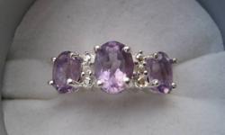 Beautiful womans purple amethyst and white topaz ring set in sterling silver very stunning looking,never worn.This is not costume jewellery.