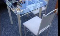 Cute glass top bistro table and matching chairs. Great for a small space or a breakfast nook.