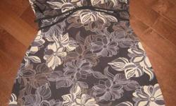 Black/Brown floral dress in size XL. Fabric is mainly polyester with some spandex in it too. So it is super comfy. The dress has cap sleeves. It also has a tie that is attached to the front and adjustable at the back. Namebrand is George. In great