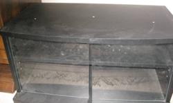 This is a TV stand in good condition, with glass doors.
It is about 14" high an 26" wide by 16" deep. It has 2 shelves inside, and one can be removed in order to fit larger items.
It is very sturdy and will hold most any TV.
If interested, send me an