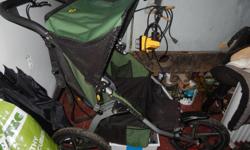 Older bob stroller. Black and green. Running stroller, front wheel does not swivle. Great shape, has hand break. In Duncan