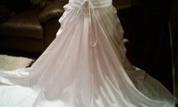 I have a NEVER BEEN WORN wedding dress!!! It fits size 8. . It is White in colour, sweetheart neckline, tie up back with a tight bodice, small amount of beading around the hip area and a ball gown skirt. Please email if you are interested. I would really