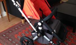 Bugaboo Chameleon Stroller / Pram in Black and Orange. Includes rain cover, cup holder, Peg Perego car seat adapter and stuff carrier. Smoke-free household.