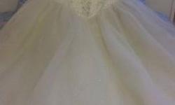 Beautiful Ivory colored Fairy tale style wedding gown.
has a full tulle skirt with clear sequins in the center and adjustable paneled strapless corseted bodice. beaded bodice has "faux" ties in the center for a timeless look.
Dress has a semi-cathedral