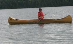 hand made white cedar canoe c/w  inlays done with walnut, cherry & butternut wood. cane seats.