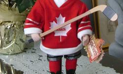 Ceramic doll of a girl brown hair blue eyes with a hockey stick and 99 jersey