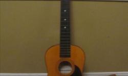 Child's first real acoustic guitar by Nova. Needs new strings. Good condition.