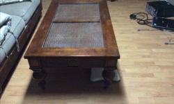50" by 30" solid wood coffee table with glass top.