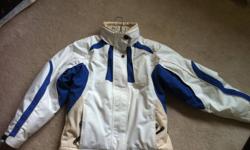 Gently used women's size 4 Couloir ski jacket. White with blue and beige highlights. Seam sealed and machine washable, extra soft material. Worn approx 10 times. No wear, stains or tears. Has all of the extras, snow skirt, interior pockets, underarm