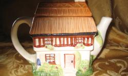This very unique "country cottage," tea pot is in very good condition, showing some slight wear on the top of the thatched roof, (the lid.)
It measures 8in. high and 7in. wide.
What a great addition to a collection, or to start one!
 
To see other tea