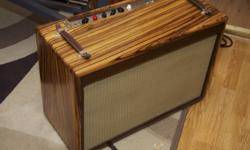 Beautiful zebrawood cabinet with a 2x12 enclosure (Eminence speakers).
The Doberman is a 40-watt, 2xEL34 Class AB guitar amplifier. The preamp section consists of one 12AT7 reverb tube, two 12AX7 pre-amp and phase-inverter tubes, with two EL34s in the