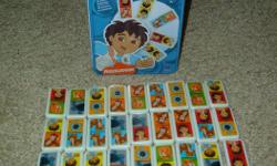 28 Piece Diego Dominoes. Glass/Ceramic pieces and complete in tin container. Excellent Condition!