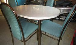 Chrome table with 4 cloth chairs.
Teal color.
This dinette set is in excellent condition.