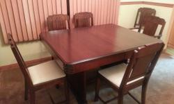 Art deco solid wood dining room suite dates to 1940's. Fully refurbished. Includes dining room table with 1 drop leaf, 6 chairs including a captain's chair, a 6 foot buffet and a china hutch with a glass door.