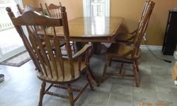 Dining Table 64" X 42"' and has a self storing leaf 18", 6 chairs, 4 regular and 2 arm chairs.  Solid Wood.Bought a smaller set as we are downsizing. Or Best offer.