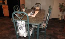 Dinning table with 6 chairs in good condition. Green in color