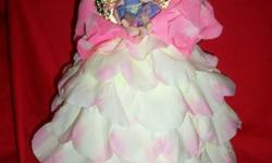 Porcelain head Fairy, dress made with flower petals and has a porcelain baby fairy, wings were also hand painted $25.00, Navy blue velveteen doll, porcelain head and hands, all hand made $25.00. Barbi dressed in red velveteen outfit with white lace dress,